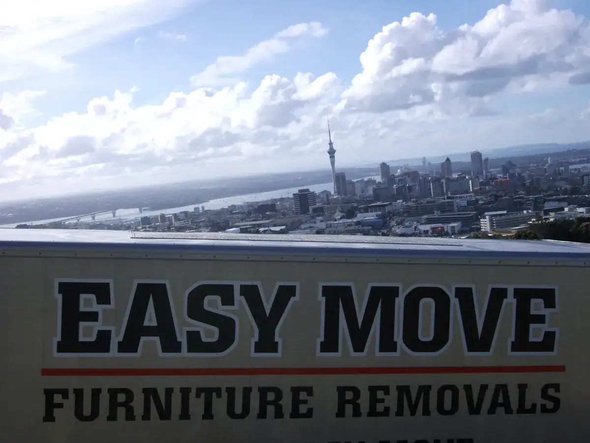 Easy Move Furniture Removals branded truck overlooking Auckland CBD and harbour