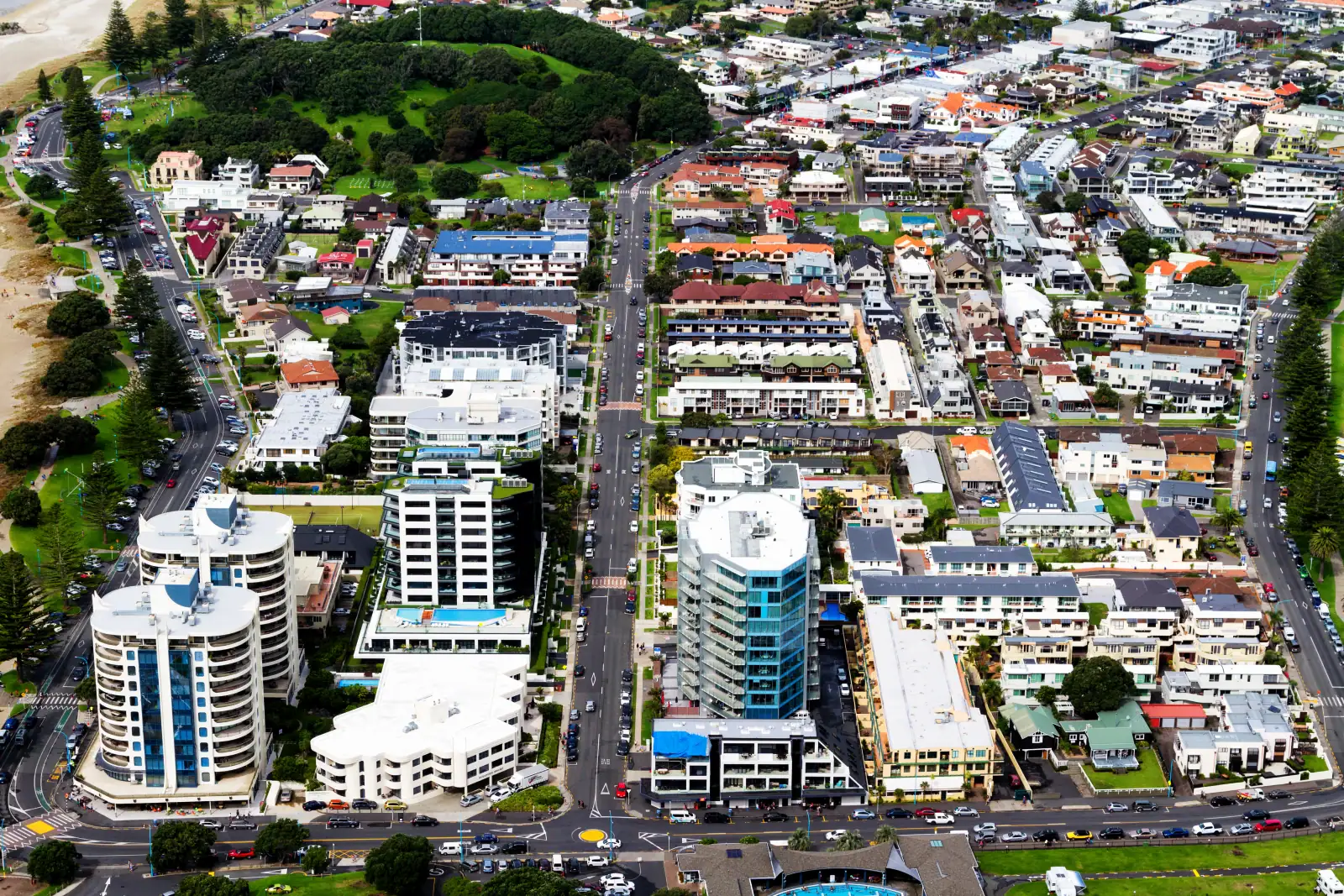 Sunset aerial view of coastal neighborhood in Akaroa, New Zealand, overlooking Mount Manganui